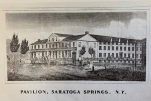 Portrait of a large white, colonial style mansion house in a huge open field.